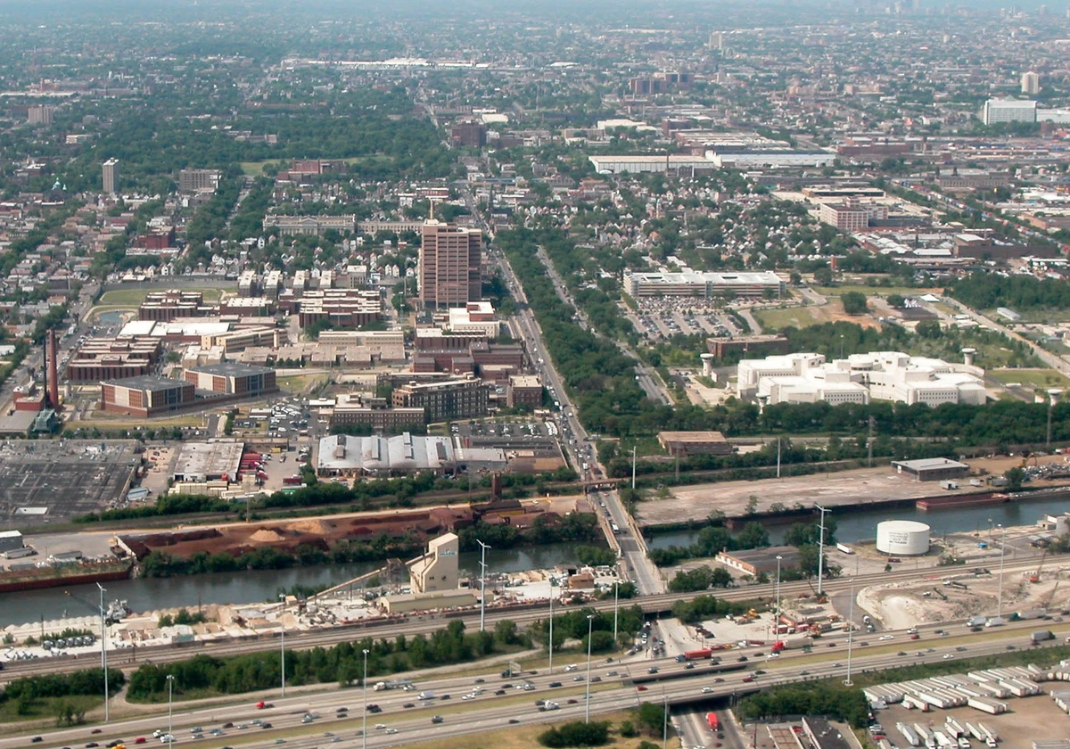 An aerial view of the Cook County Jail complex in Chicago, a wide spread of brick and white buildings beside a river and an expressway